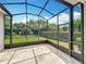 Enclosed screened patio providing an excellent view of the backyard and surrounding landscape at 903 Kersfield Cir, Lake Mary, FL 32746