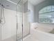 Bathroom featuring separate glass shower and oval soaking tub with a large window offering natural light at 903 Kersfield Cir, Lake Mary, FL 32746