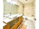 Well-lit bathroom featuring stylish vanity, patterned tile, and combined tub and shower at 9490 Sw 85Th Ave # E, Ocala, FL 34481