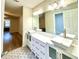 Bright bathroom featuring a double vanity with vessel sinks and modern fixtures, plus patterned tile floor at 9490 Sw 85Th Ave # E, Ocala, FL 34481