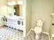 Bathroom featuring double vanity with vessel sinks, patterned tile flooring, and toilet at 9490 Sw 85Th Ave # E, Ocala, FL 34481