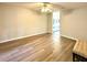 Bedroom with hardwood floors and ceiling fan; doorway to bathroom with double sinks at 9490 Sw 85Th Ave # E, Ocala, FL 34481