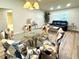 Open-concept living and dining area with vaulted ceilings and laminate flooring at 9490 Sw 85Th Ave # E, Ocala, FL 34481