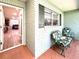 Inviting front porch with brick detail, flanked by chairs and overlooking a glimpse of the home's living area at 9490 Sw 85Th Ave # E, Ocala, FL 34481