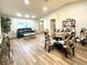 Open-concept living and dining area with vaulted ceilings and laminate flooring at 9490 Sw 85Th Ave # E, Ocala, FL 34481