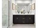 Elegant bathroom with double vanity, marble-look shower, and modern fixtures creating a spa-like experience at 9964 Red Canoe Aly, Orlando, FL 32832