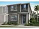 Charming two-story townhome featuring a welcoming front entrance, manicured landscaping, and a classic design at 9964 Red Canoe Aly, Orlando, FL 32832