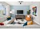 Well-decorated living area with a plush sofa, stylish artwork, and plenty of natural light at 9964 Red Canoe Aly, Orlando, FL 32832