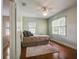 Comfortable bedroom featuring hardwood floors, a ceiling fan, a soft rug, and neutral colors creating a calm atmosphere at 1000 Pennsylvania Ave, Lakeland, FL 33803