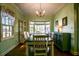 Traditional dining room featuring a window seat, hardwood floors, built-in cabinet and elegant chandelier at 1000 Pennsylvania Ave, Lakeland, FL 33803