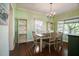 Dining room featuring hardwood floors, natural lighting, a traditional chandelier, and stylish decor at 1000 Pennsylvania Ave, Lakeland, FL 33803