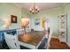 An open dining area features wood flooring and trim, traditional chandelier, and stylish decor at 1000 Pennsylvania Ave, Lakeland, FL 33803