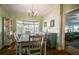 Charming dining room with natural light from a window seat, and hardwood flooring, adjacent to living room at 1000 Pennsylvania Ave, Lakeland, FL 33803