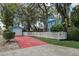 View of the exterior of the blue house with a detached garage and a white picket fence at 1000 Pennsylvania Ave, Lakeland, FL 33803