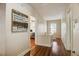 Inviting hallway featuring hardwood floors, calming decor, and doorways to bathroom and bedroom areas at 1000 Pennsylvania Ave, Lakeland, FL 33803