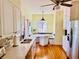 Bright kitchen featuring stainless steel appliances, breakfast nook with seating, and modern fixtures at 1000 Pennsylvania Ave, Lakeland, FL 33803