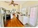 Galley kitchen boasts stainless steel appliances, white cabinets, and mosaic backsplash, with a view to nook at 1000 Pennsylvania Ave, Lakeland, FL 33803