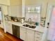 This kitchen features stainless steel appliances, bright white cabinets, and a stylish mosaic backsplash at 1000 Pennsylvania Ave, Lakeland, FL 33803