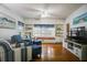 Bright living room with hardwood floors, a window seat, built-in shelving, and comfortable seating at 1000 Pennsylvania Ave, Lakeland, FL 33803
