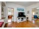 Open-concept living room with hardwood floors, built-in shelves, a modern TV stand, and a connecting breakfast nook at 1000 Pennsylvania Ave, Lakeland, FL 33803