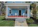 Inviting front porch with classic columns, white Adirondack chairs, and stone walkway at 1000 Pennsylvania Ave, Lakeland, FL 33803