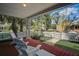 Cozy covered front porch showcasing white Adirondack chairs, offering a relaxing outdoor space at 1000 Pennsylvania Ave, Lakeland, FL 33803