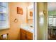 Charming powder room featuring a vanity with decorative fixtures, an ornate framed mirror, and rustic signage at 1000 Pennsylvania Ave, Lakeland, FL 33803