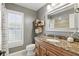 Bathroom featuring a granite countertop, wood vanity, and framed mirror at 1129 Golfside Dr, Winter Park, FL 32792