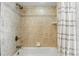 Neutral bathroom with a tile shower-tub, chrome showerhead and white shower curtain at 1129 Golfside Dr, Winter Park, FL 32792