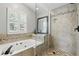 Bathroom featuring a separate jetted tub and glass enclosed shower with decorative mosaic tile accents at 1129 Golfside Dr, Winter Park, FL 32792