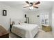 Bedroom with wood floors, a ceiling fan, a bed, and plantation shutters at 1129 Golfside Dr, Winter Park, FL 32792