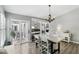 Bright dining room with a modern chandelier, sliding doors to the outdoor patio, and wood laminate flooring at 1129 Golfside Dr, Winter Park, FL 32792