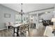 Open dining room with hardwood floors, chandelier, views of pool, and lots of natural light at 1129 Golfside Dr, Winter Park, FL 32792