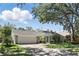 Traditional-style home with well-manicured lawn, mature trees, and a two-car garage adding curb appeal at 1129 Golfside Dr, Winter Park, FL 32792