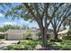 Classic home with lush greenery, a large shade tree, and a well-maintained front lawn showcasing curb appeal at 1129 Golfside Dr, Winter Park, FL 32792