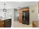 Well-lit kitchen featuring stainless steel refrigerator, granite countertops, and ample cabinet space at 1129 Golfside Dr, Winter Park, FL 32792
