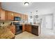 A well-equipped kitchen with ample counter space, tiled floor, wooden cabinets, and stainless steel appliances at 1129 Golfside Dr, Winter Park, FL 32792