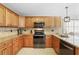 Updated kitchen with granite counters, custom cabinets, stainless appliances, and tiled backsplash at 1129 Golfside Dr, Winter Park, FL 32792