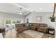 A spacious living room boasts a vaulted ceiling, a ceiling fan, a cozy sectional, and sliding doors at 1129 Golfside Dr, Winter Park, FL 32792