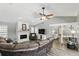 A traditional living room with a fireplace, a comfortable seating area, and lots of natural light at 1129 Golfside Dr, Winter Park, FL 32792