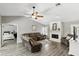 A cozy living room with a fireplace, comfortable seating, and a view into the adjacent bedroom at 1129 Golfside Dr, Winter Park, FL 32792