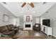 Cozy living room featuring a fireplace, hardwood floors, and plenty of seating at 1129 Golfside Dr, Winter Park, FL 32792