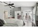 This bedroom has wood floors, a ceiling fan, and a door that opens to an outdoor sitting area at 1129 Golfside Dr, Winter Park, FL 32792