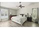 Spacious main bedroom with wood floors, a ceiling fan, and bright, shuttered windows at 1129 Golfside Dr, Winter Park, FL 32792