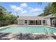 Relaxing backyard with pool, brick pavers, and charming covered porch ideal for entertaining and lounging at 1129 Golfside Dr, Winter Park, FL 32792