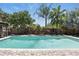 Lush backyard pool with brick paver patio, tropical plants, wooden pergola, and mature privacy fence at 1129 Golfside Dr, Winter Park, FL 32792