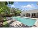 Sparkling swimming pool with a brick deck and lush tropical landscaping, perfect for entertaining at 1129 Golfside Dr, Winter Park, FL 32792