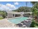 Spacious backyard features a refreshing pool, brick pavers, and mature trees perfect for outdoor enjoyment at 1129 Golfside Dr, Winter Park, FL 32792