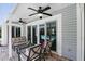 Covered porch featuring comfortable seating, ceiling fans, and views of the pool through sliding glass doors at 1129 Golfside Dr, Winter Park, FL 32792