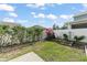 Lush backyard featuring a white fence with blooming bougainvillea and a small garden at 12936 Freeman St, Windermere, FL 34786